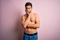 Young handsome strong man with beard shirtless standing over isolated pink background thinking looking tired and bored with Royalty Free Stock Photo