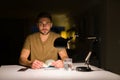 Young handsome student man studying at night at home with a confident expression on smart face thinking serious Royalty Free Stock Photo