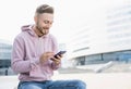 Young handsome student man using smartphone. Cheerful men holding mobile phone, technology, people concept Royalty Free Stock Photo