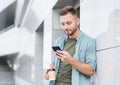 Young handsome student man using smartphone. Cheerful men holding mobile phone, technology, people concept Royalty Free Stock Photo