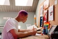 Young handsome stylish focused boy doing homework Royalty Free Stock Photo