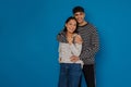 Young handsome stylish guy hugging his happy beautiful asian girlfriend Royalty Free Stock Photo