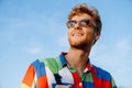 Young handsome stylish smiling man in colorful shirt and glasses Royalty Free Stock Photo