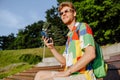 Young handsome stylish smiling man in sun glasses with phone Royalty Free Stock Photo