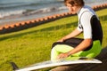 Young handsome surfer preparing surf table Royalty Free Stock Photo
