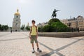 Young handsome teen boy happy smiling over Cathedral of St. Sophia of Kyiv and monument to Bohdan Royalty Free Stock Photo