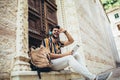 Handsome tourist men using digital tablet in a city listening to music Royalty Free Stock Photo