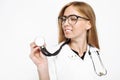 Young handsome trainee doctor in glasses, using a stethoscope to