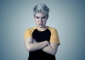 Portrait of a young transgender teenager boy with angry face looking furious