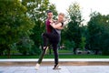 Young passionate couple dancing tango in city park Royalty Free Stock Photo