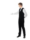 Young handsome waiter doing a welcome gesture Royalty Free Stock Photo