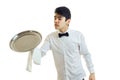 Young handsome waiter holding a large tray for Cookware Royalty Free Stock Photo