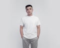 Young handsome wearing white t shirt short sleeve isolated on background