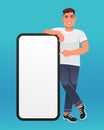Young handsome white man points to the screen of a large smartphone. Advertising of a mobile application or services, promotion of