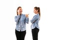 Young handsome woman arguing with herself on white studio background.