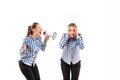 Young handsome woman arguing with herself on white studio background.