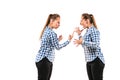 Young handsome woman arguing with herself on white studio background.