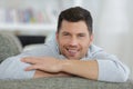 young handsomeman sitting on sofa Royalty Free Stock Photo