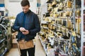 Young handyman checking information on his mobile Royalty Free Stock Photo