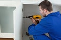 Young handyman fixing a door Royalty Free Stock Photo