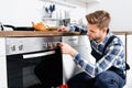 young repairman in uniform on blurred