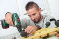 Young handyman using electric drill, DIY at home Royalty Free Stock Photo