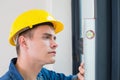 Young handyman using a spirit level Royalty Free Stock Photo