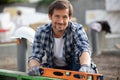 young handyman using spirit level outdoors Royalty Free Stock Photo