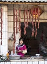 Young Hani Girl selling Sausage