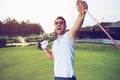 Happiness winner man golfer putting a golf ball in to hole Royalty Free Stock Photo