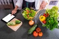 Young happiness Woman Cooking vegetables salad in the kitchen, H Royalty Free Stock Photo