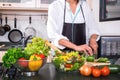 Young happiness Woman Cooking vegetables salad in the kitchen, H Royalty Free Stock Photo