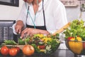 Young happiness Woman Cooking vegetables salad in the kitchen Royalty Free Stock Photo