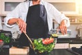 Young happiness Woman Cooking vegetables salad in the kitchen, H Royalty Free Stock Photo