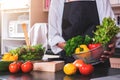 Young happiness Woman Cooking vegetables salad in the kitchen, H Royalty Free Stock Photo