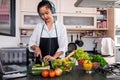 Young happiness Woman Cooking vegetables salad in the kitchen, H Royalty Free Stock Photo