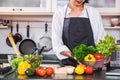 Young happiness Woman Cooking vegetables salad in the kitchen, H Royalty Free Stock Photo