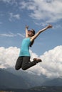 Young happiness woman is jumping against blue sky. summer sunny day Royalty Free Stock Photo