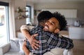 Young happy adult brothers in kitchen indoors at home, hugging. Royalty Free Stock Photo