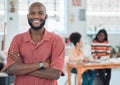 Young happy african american businessman standing with his arms crossed while in an office. Confident male manager Royalty Free Stock Photo