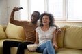 Young happy african american couple watching funny movie. Royalty Free Stock Photo