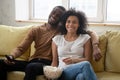 Young happy african american couple watching funny tv show. Royalty Free Stock Photo