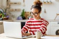 Young happy African American woman freelancer smiling at camera, enjoying remote work at home office Royalty Free Stock Photo