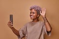 Young happy African American woman looking at phone doing video blogging Royalty Free Stock Photo