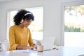 Young happy African American woman student using laptop elearning at home. Royalty Free Stock Photo