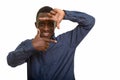 Young happy African man smiling and focusing with fingers