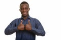 Young happy African man smiling giving thumbs up