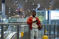 Young happy african traveler man using mobile phone, texting sms message after arrival in airport Royalty Free Stock Photo