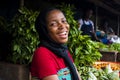 young happy african woman selling in a local market laughing