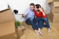 Young happy American couple sitting on floor celebrating moving Royalty Free Stock Photo